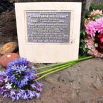 A plaque dedicated to "Liberated Africans" in St. Helena with flowers around it. Credits: St Helena Government, CC BY-SA