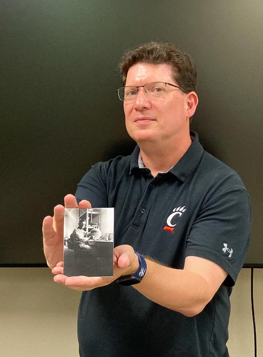 University of Cincinnati Classics researcher and archivist Jeff Kramer holds up a photo of Emin Kani Barin, a laborer from Albania who served an important role in archaeological excavations of Troy in the 1930s. Credits: Michael Miller