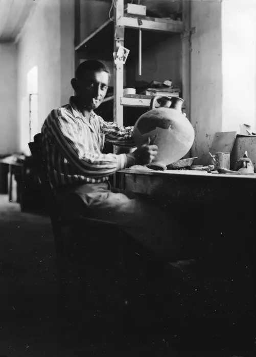Emin Kani Barin, a laborer from Albania, holds one of the pots he helped repair at Troy. A new paper by University of Cincinnati Archivist Jeff Kramer examines the important but unheralded role workers played in the 1930s excavation. Credits: UC Classics