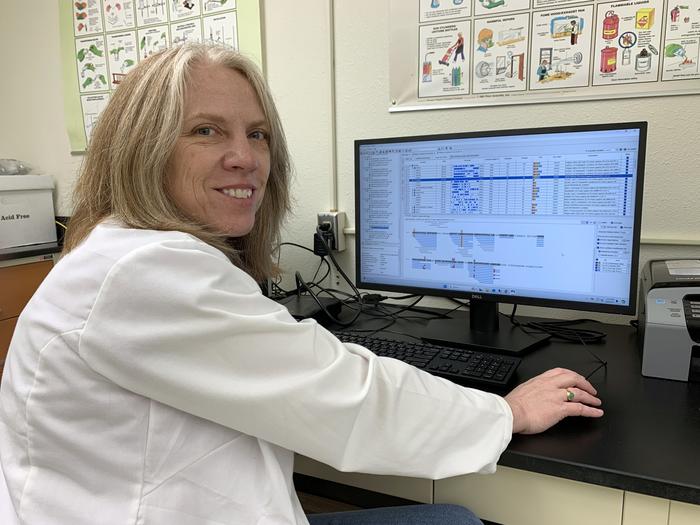Tammy Buonasera, assistant professor at the University of Alaska Fairbanks, looks at test results from her study of proteins in tooth enamel. Photo courtesy of Tammy Buonasera, CC BY-NC-ND