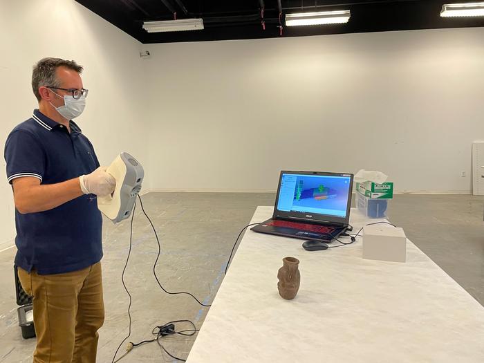 University of South Florida scholar Davide Tanasi creates a 3-D replica of the Egyptian Bes mug used in the study. Credits: Cassidy Delamarter