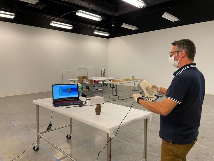 University of South Florida scholar Davide Tanasi creates a 3-D replica of the Egyptian Bes mug used in the study. Credits: Cassidy Delamarter