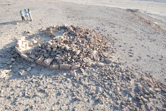 Researchers look over the remains of a platform monument, the largest type of monument studied. They were generally created in a single session, by multiple individuals. Photo Credits: Joy McCorriston, The Ohio State University