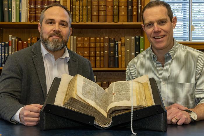 James Wade (left) and Seb Falk (right) with Peterhouse MS 255 open at the sermon, in the University Library in Cambridge. Credits: Courtesy of the Master and Fellows of Peterhouse / University of Cambridge