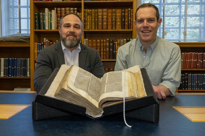 James Wade (left) and Seb Falk (right) with Peterhouse MS 255 open at the sermon, in the University Library in Cambridge. Credits: Courtesy of the Master and Fellows of Peterhouse / University of Cambridge
