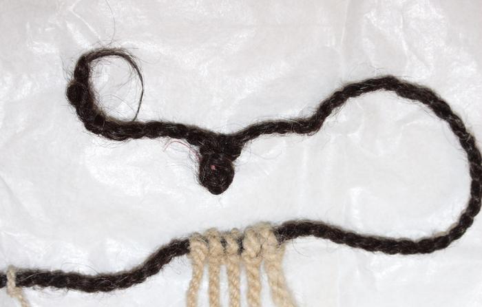 Dark brown human hair primary cord on Inka khipu KH0631. Photo Credits: Sabine Hyland